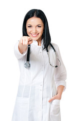 Smiling medical doctor woman pointing finger to you isolated on white background