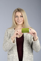Pretty young girl shows a business card.