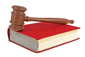 Wooden mallet and book on a white background