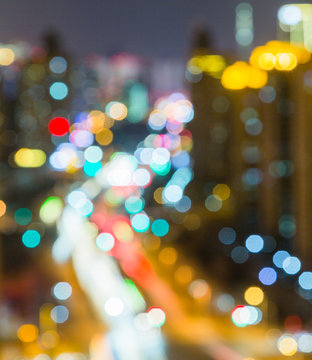 Abstract bright multicolored lights against city skyline.