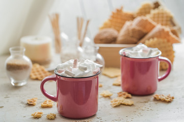 two cups of cocoa with marshmallows