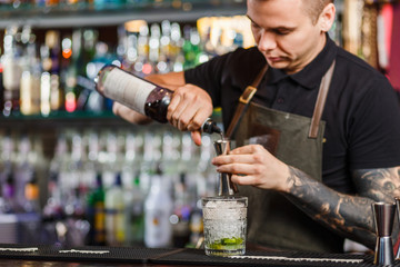 The bartender making cocktail