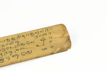 detail of a preserved palm leaf (borassus flabellifer) manuscripts showing writings about ayurvedic medicines in old malayalam script from Kerala, India