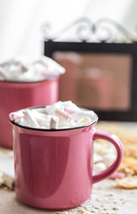 two cups of cocoa with marshmallows