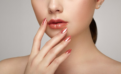 Beauty brunette woman with perfect makeup. Glamour girl. Red lips and nails. Skin care foundation....