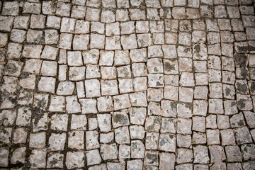 Background of old stone road. Old town of Lisbon, Portugal. Middle ages texture