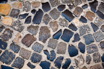 Background of old stone road. Old town of Lisbon, Portugal. Middle ages texture
