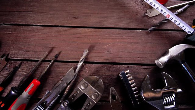 Many old rusty tools and modern tablet on desk