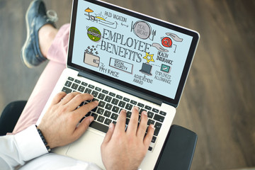 People using laptop and EMPLOYEE BENEFITS concept on screen