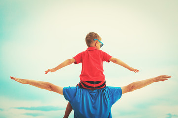 Fototapeta na wymiar father and son having fun on sky