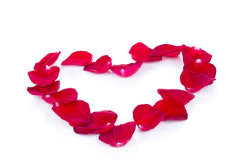 Beautiful heart of red rose petals isolated on white. Valentines heart border over white.