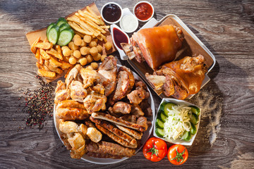 Myanoe arosti grill on wooden boards with fries and vegetables. The concept of grill, barbecue.