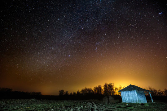 Barn under starry sky at night