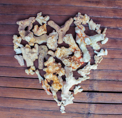 Heart from white corals on wooden background. Seashore love decor from beach finding.