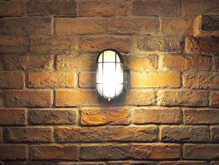 Brick wall old dirty texture background and hanging lamp.