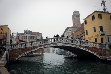 Fototapeta na wymiar Scenic canals and bridges of foggy Venice, Italy