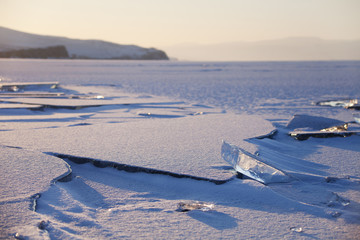Ice on Baikal Lake, winter. Sunset landscape.