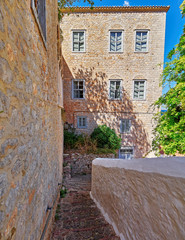 Fototapeta na wymiar Greece, Hydra island, stairs alley and old shipowner mansion