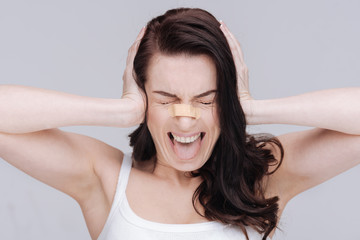 Fototapeta premium Emotional young lady overwhelmed with criticism