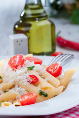 Pasta with cherry tomatoes, chili pepper and basil