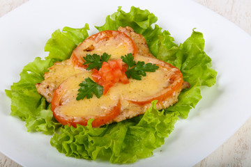 Pork baked with tomato and cheese