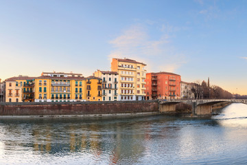Fototapeta na wymiar historical quarter of Verona, panorama from river on Duomo Cathedral at sunrise