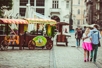Man and woman in pink skirt woalk around the old city