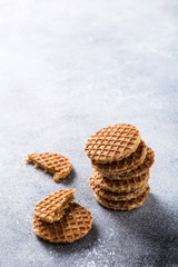 Glass cups of coffee with mini stroopwafel, syrupwaffles cookies on light gray background with copy space.