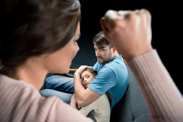 father protecting daughter from aggressive mother, family violence concept