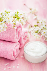 Fototapeta na wymiar Rolled pink towel with flowers