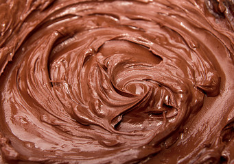 Melted chocolate. Chocolate swirl. Liquid chocolate as background