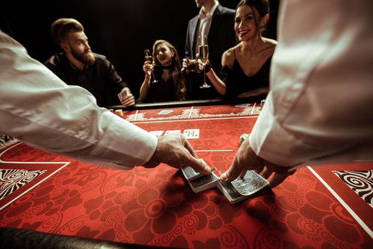 Close Up View Of Dealer Shuffling Cards In Hands