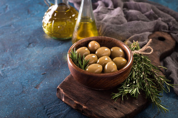 bowls with different kind of olives green olives, black olives, kalamata olives on table