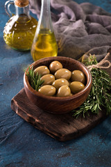 bowls with different kind of olives green olives, black olives, kalamata olives on table