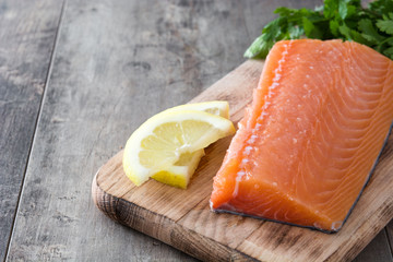 Raw salmon fillet on wooden background
