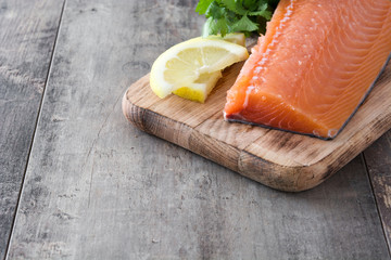 Raw salmon fillet on wooden background
