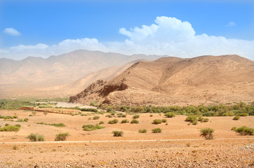 Lonely road near mountains in desert of Morocco. High Atlas