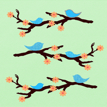 Blue birds with rhinestones diamond on flowering branches on the light green background