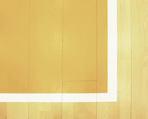 White corner and yellow field. Worn out wooden floor