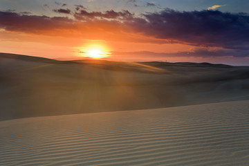 Fototapeta na wymiar Sand Dune Sun Pink Over
