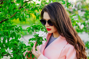 happy girl in the spring . a touch of spring , a young girl in sunglasses