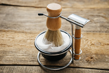 mens shaving kit on wooden background