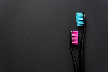 colourful toothbrushes  on black background