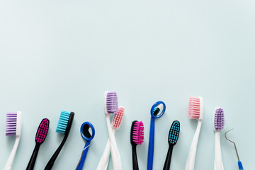 colourful toothbrushes on blue background