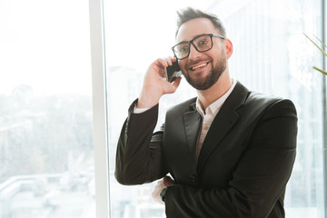 Bearded business man talking on phone