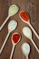different types of sauces in spoons