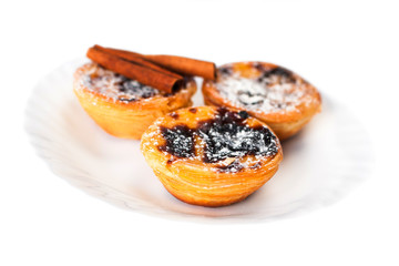 Creamy sweet egg curstard with black crust and sugar powder isolated on white. Pasteis de Nata  egg tart