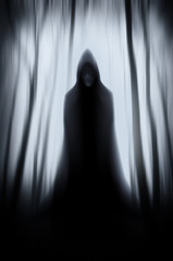 scary ghost in surreal dark Halloween forest landscape