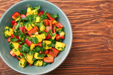 Mango salad with pepper and parsley in a bowl