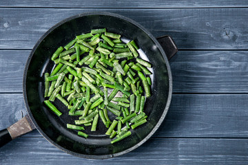 Cuted green french bean on the pan ready for frying.